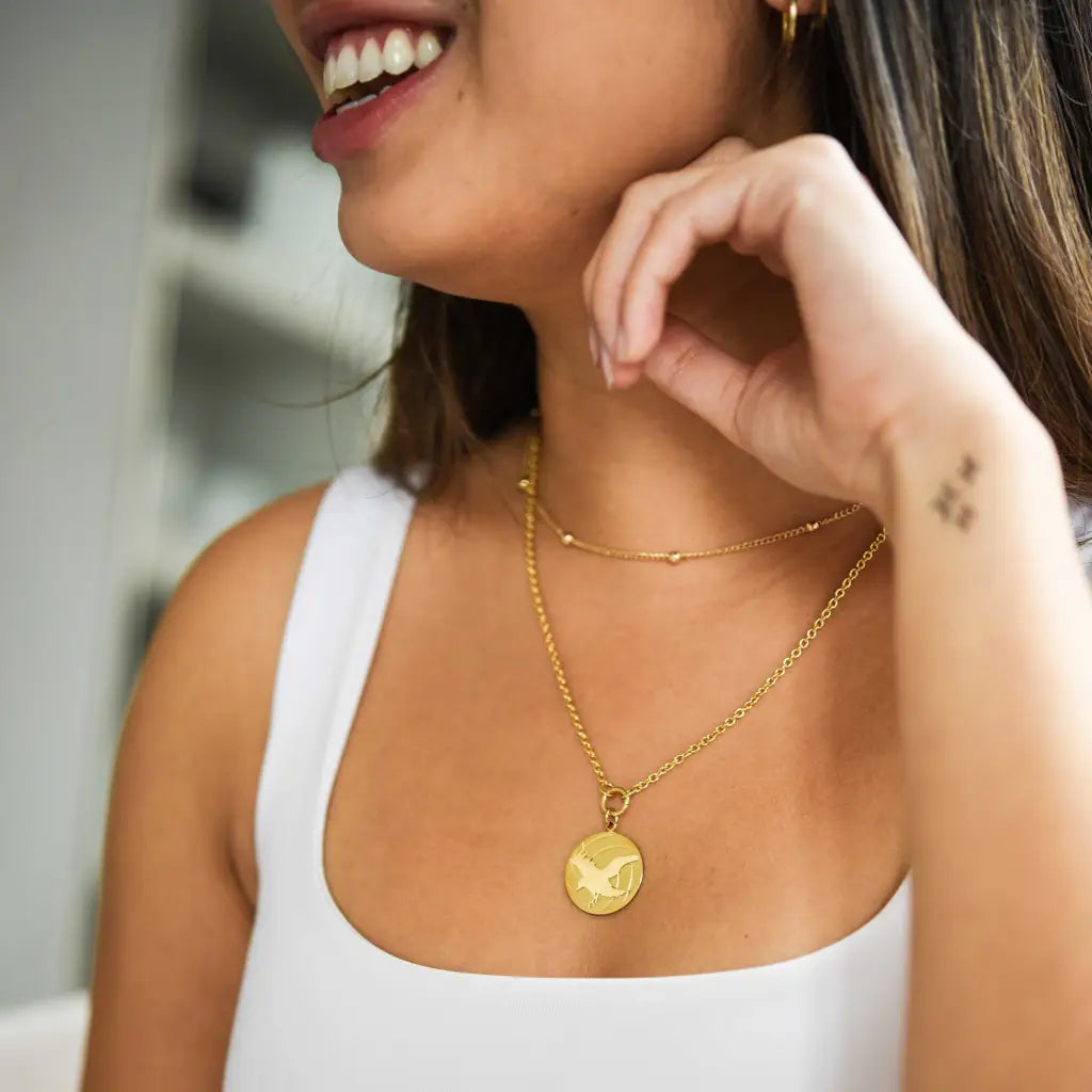 model wearing haikyuu karasuno crows gold necklace