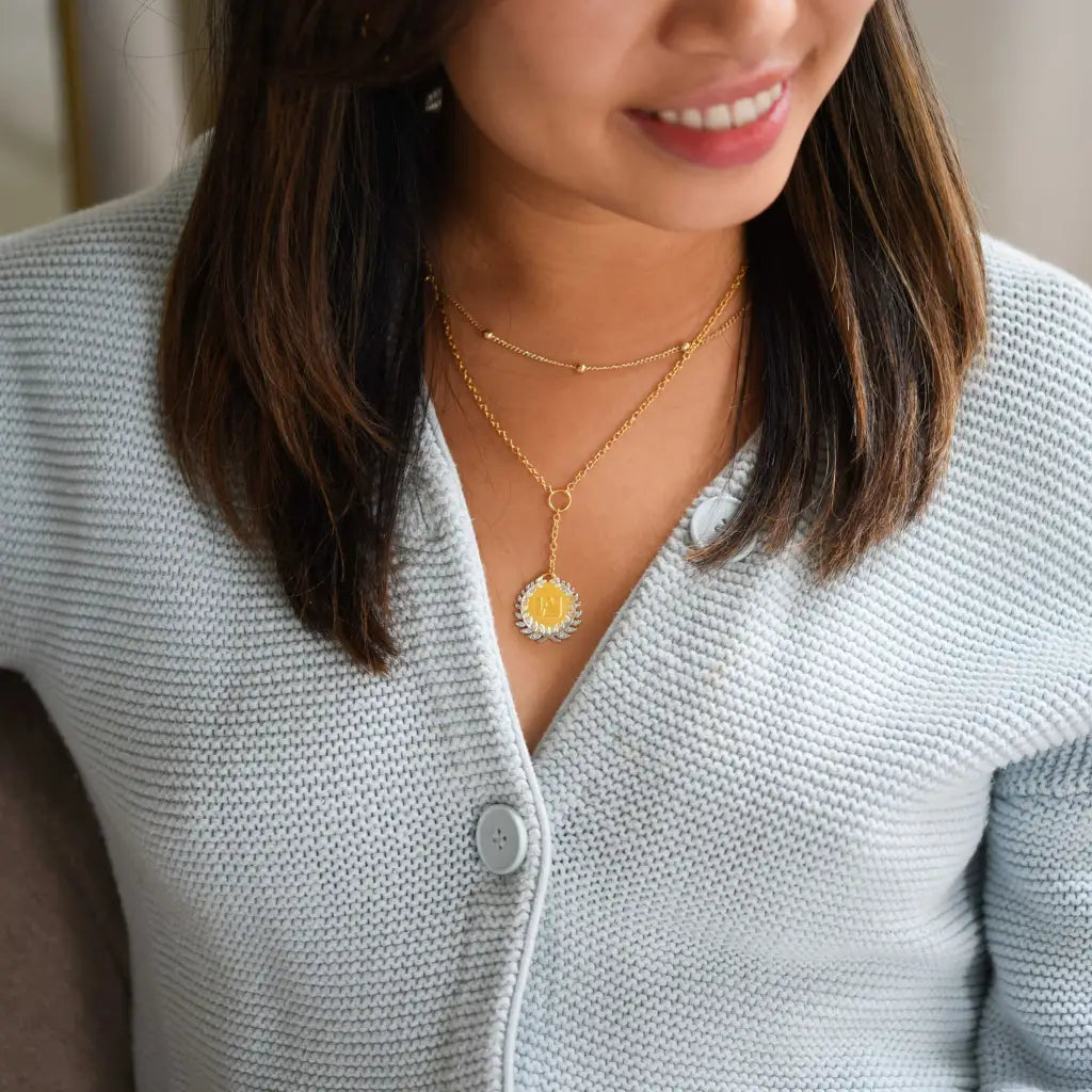 model wearing my hero academia u.a. high gold necklace